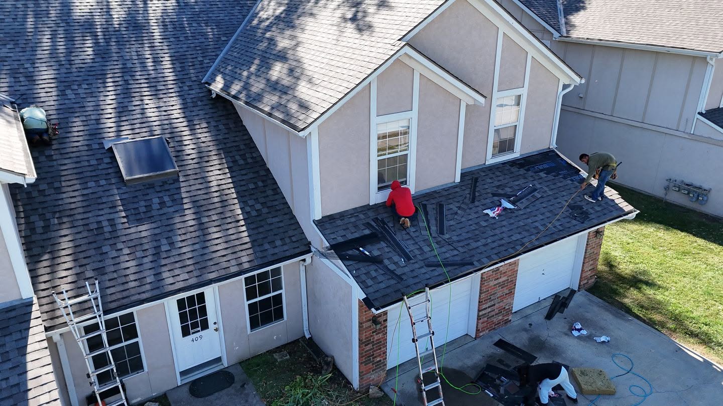 Brown Roofing crew installing new shingles